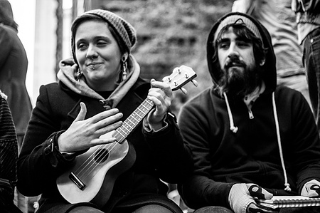 Two protestors at Occupy Wall Street in 2011. One is playing a ukulele. 