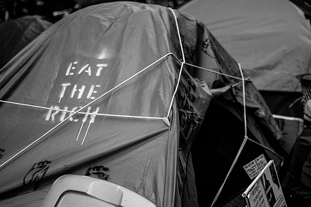 A tent set up that says eat the rich at Occupy Wall Street