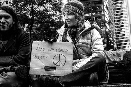 Protestor holding up a sign of Occupy Wall Street in 2011