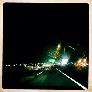 A photo of a highway through a smeared windshield 