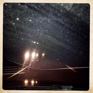 A vintage styled photograph of a highway at night