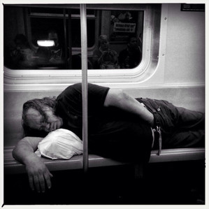 Homeless man reaching into his pants on the New York City subway