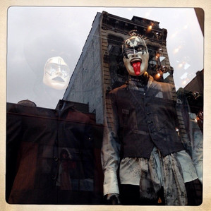 Masks of Paul Stanley and Gene Simmons from Kiss on display in a store window in New York City