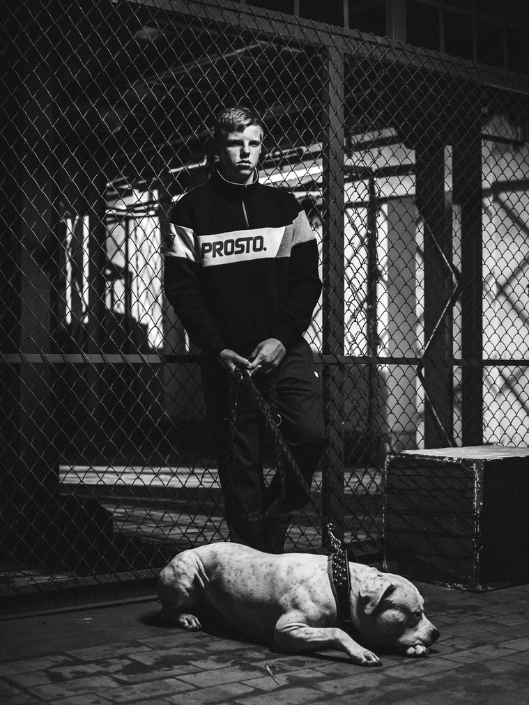 A man and a dog resting in warehouse wearing PROSTO. hoodie shot by Piotr Książek