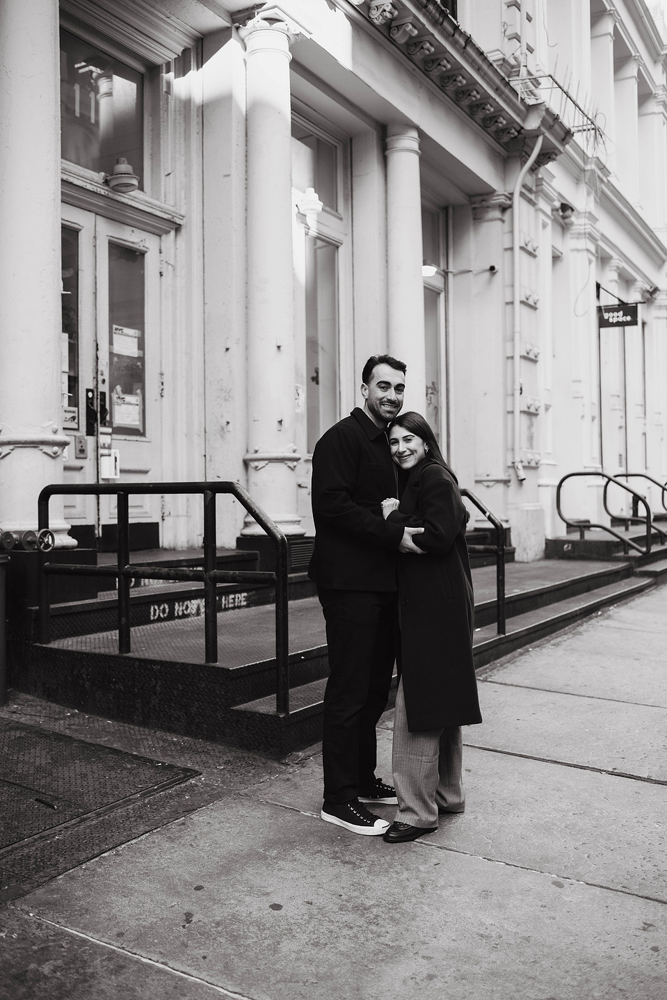 Engaged couple embraces on streets of SoHo, New York City