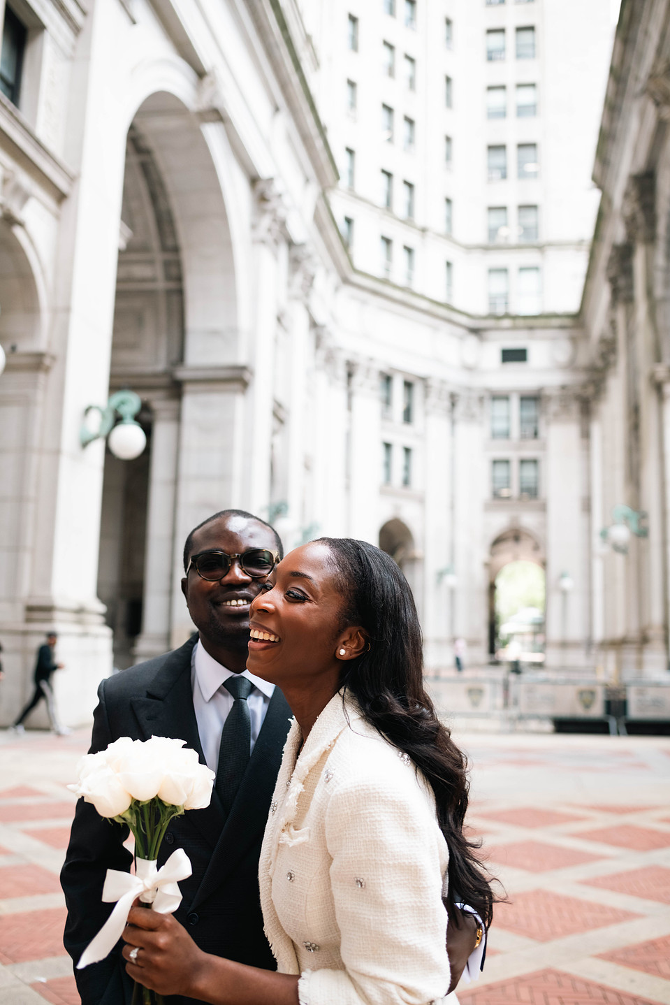 Wedding couple walking outside the David N. Dinkins Manhattan Municipal Building