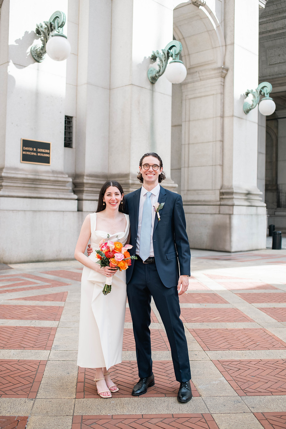Wedding couple walking outside the David N. Dinkins Manhattan Municipal Building