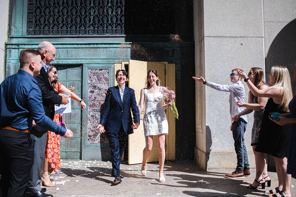Just married couple in front of the green doors at Manhattan City Hall
