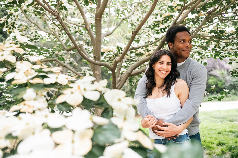 Engaged couple under trees in Prospect Park during a Brooklyn engagement session