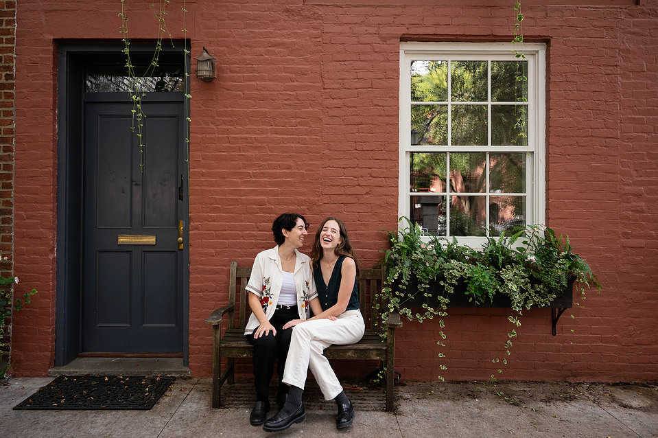 Couple sitting in front of a classic Brooklyn brownstone near Cobble Hill Park