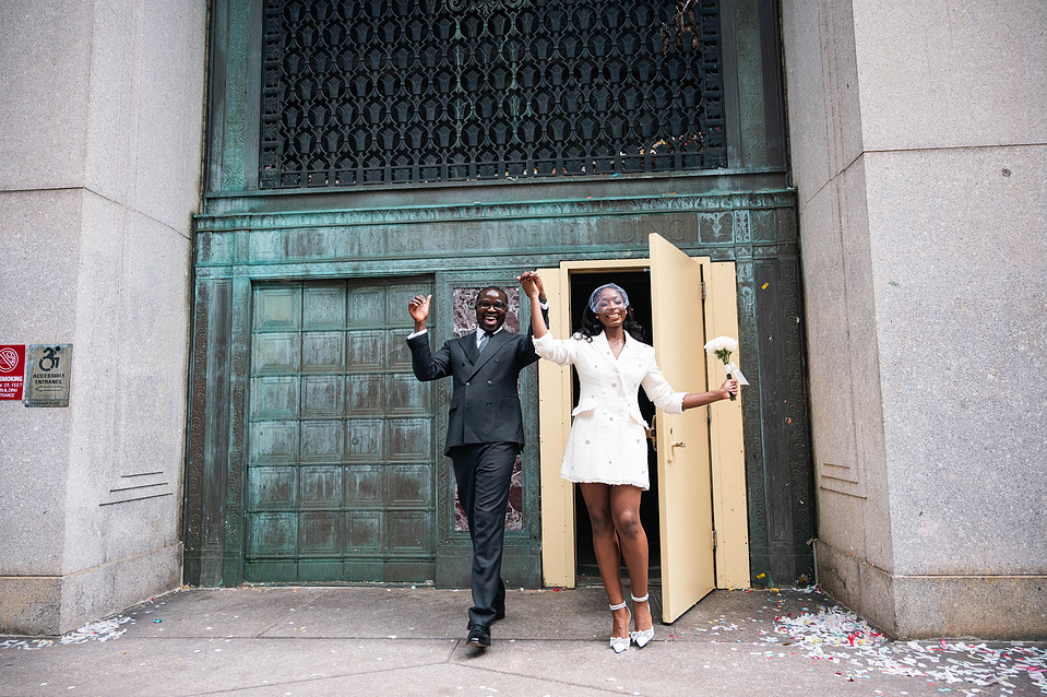 Just married couple in front of the green doors at Manhattan City Hall