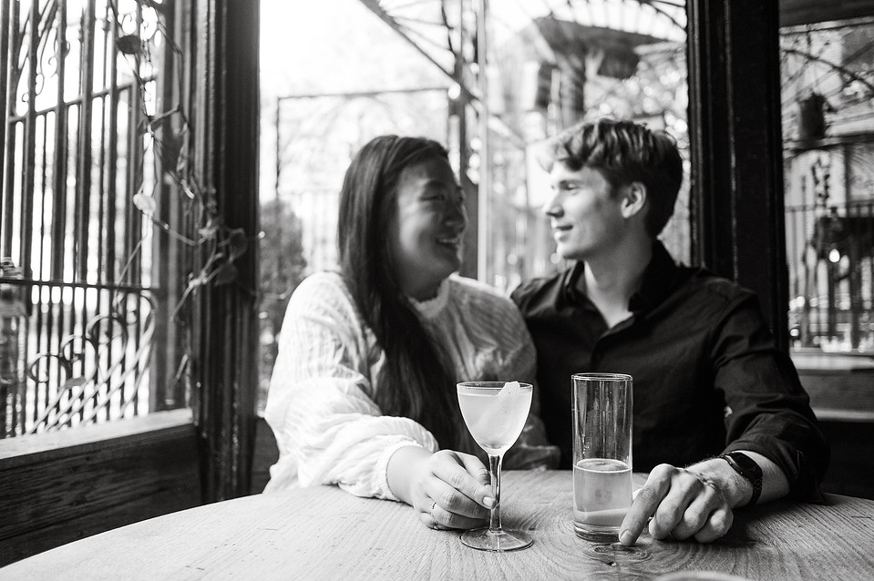 Candid engagement photo of couple in a Brooklyn restaurant