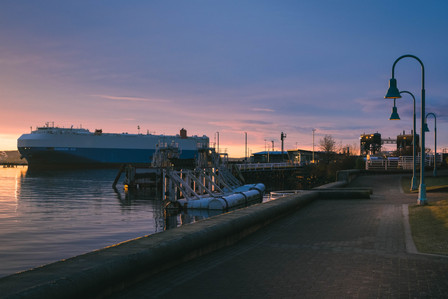 The sun rises behind a Freighter at Nanaimo Port Authority.