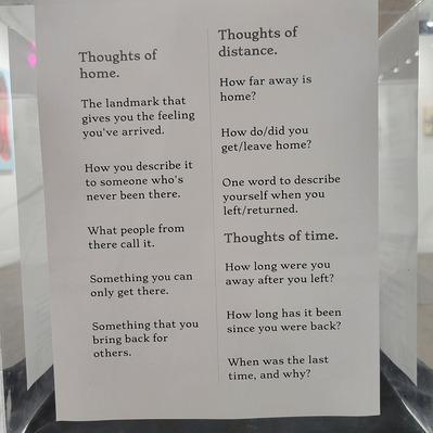 A printed page of prompts  for participation.  
including.
 
"The landmark that gives you the feeling you've arrived."

"One word to describe yourself when you left/returned"