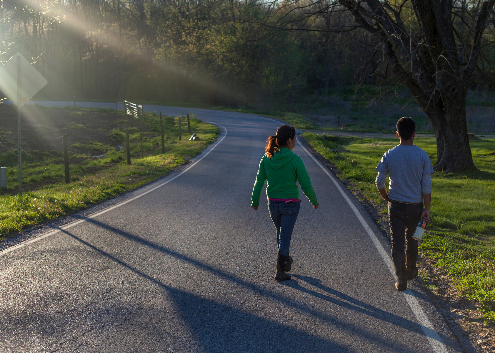 Manuel Tzanahua Zacarias and Sylvia Ramirez Reyes walk down the hill from Kenny’s Cheesehouse farms to their home after finishing their afternoon shift on Monday, April 4. The house they now live in used to belong farm owner’s son until he got married and