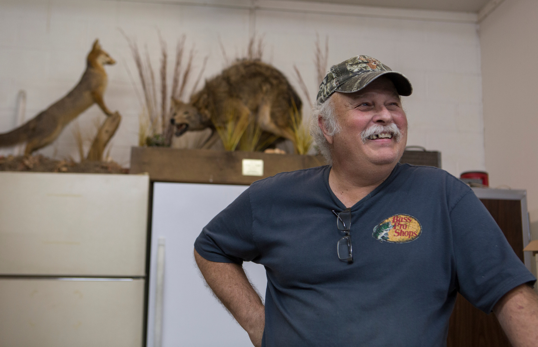 Howard jokes around as he rings up bait for a customer. He initially started solely with taxidermy and later added bait and fishing supplies. Howard grew up in Paducah hunting and fishing so his profession allows him to enjoy