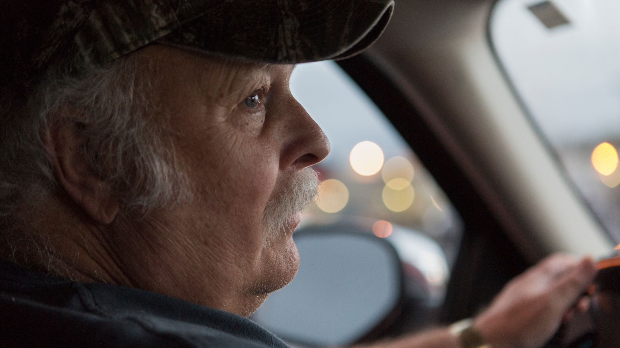 Howard checks his mirror while driving to dinner with JoAnne. The couple often prefers to eat out instead of cooking at home after a long work day.