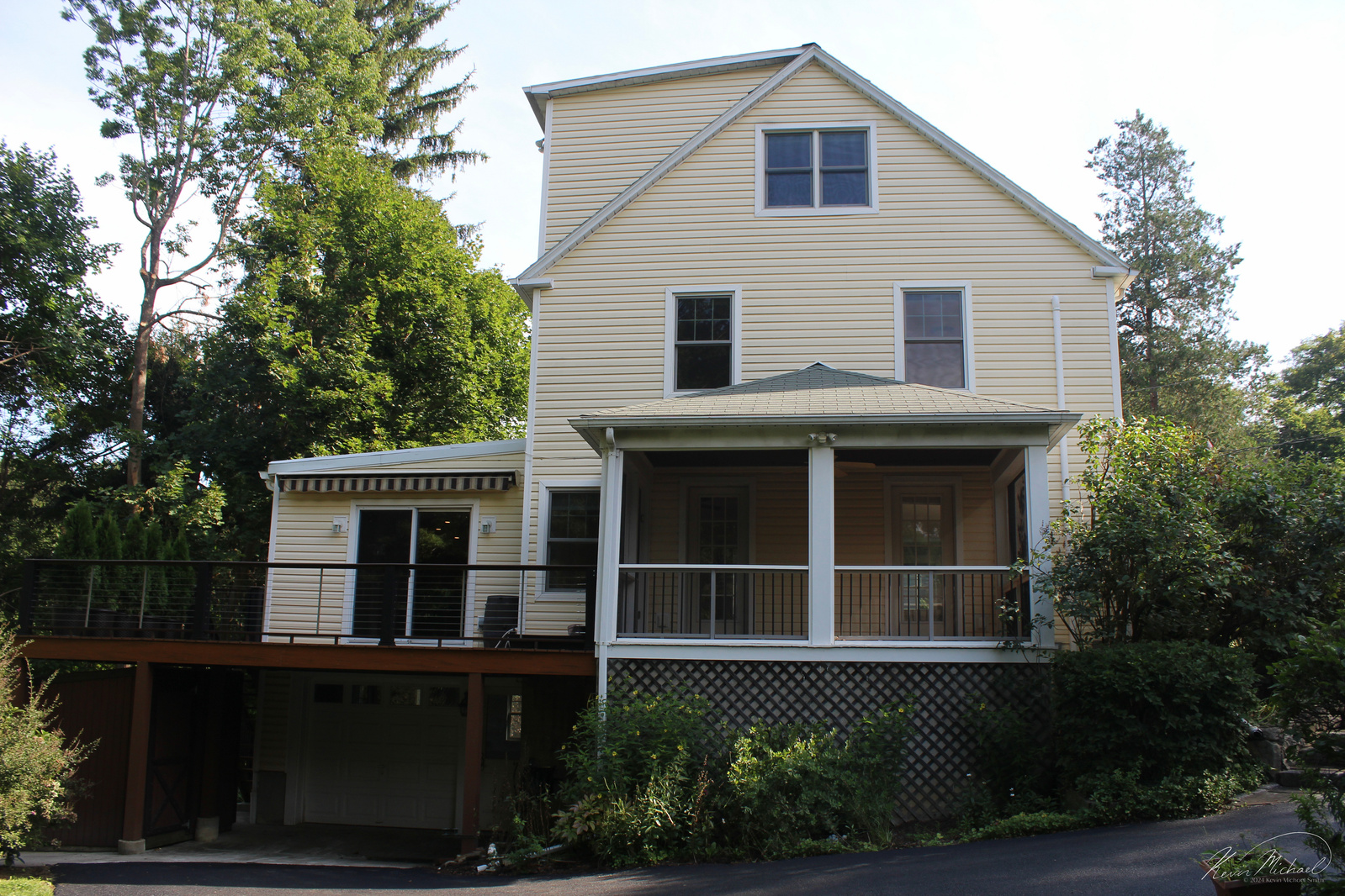 Real Estate Photography, in Westchester County, New York by Vermont-based Artist & Photographer, Kevin Michael Smith. Exterior photo of yellow house with deck, four season room, garage. 
Rutland Photographer.
