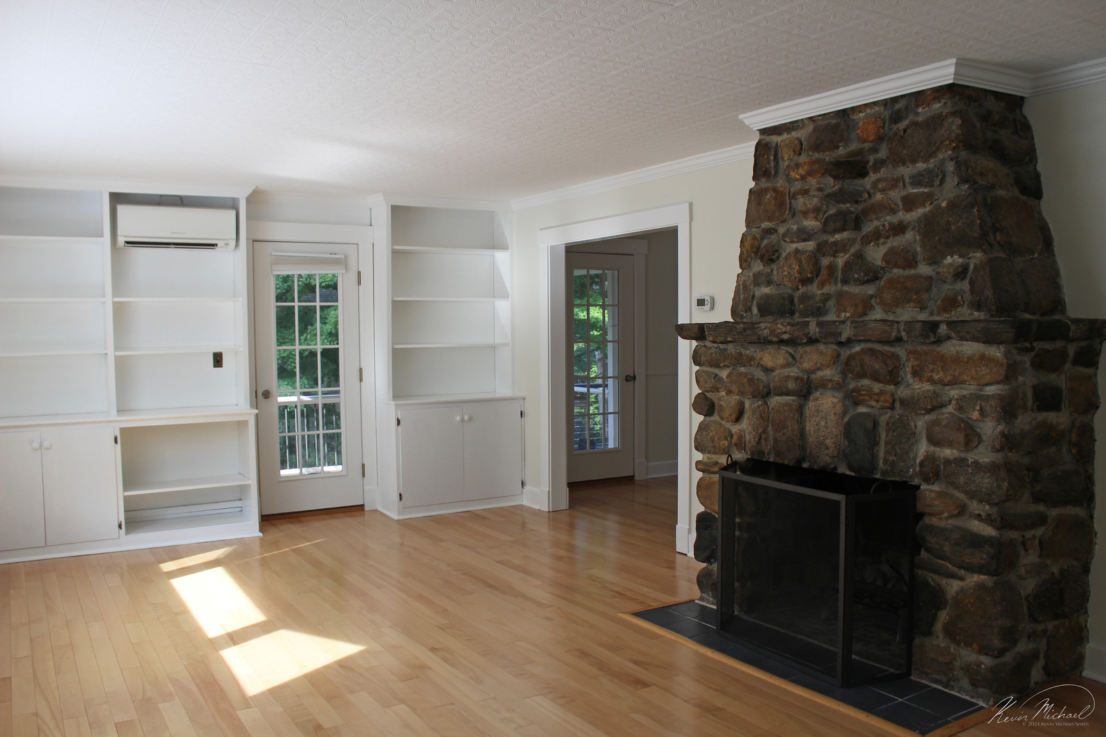 Real Estate Photography, in Westchester County, New York by Vermont-based Artist & Photographer, Kevin Michael Smith. Photo of Living Room with a fireplace, hardwood floors and natural light. 
Rutland Photographer.
