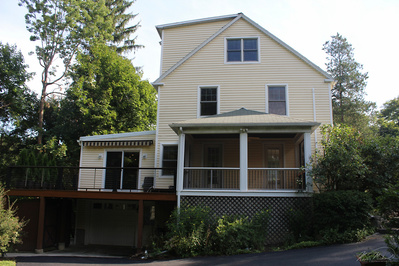 Real Estate Photography, in Westchester County, New York by Vermont-based Artist & Photographer, Kevin Michael Smith. Exterior photo of yellow house with deck, four season room, garage.
Rutland Photographer.