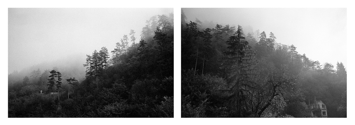 Foggy hills with destroyed buildings overlooking Srebrenica's city center.