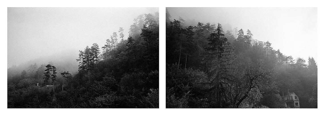 Foggy hills with destroyed buildings overlooking Srebrenica's city center.