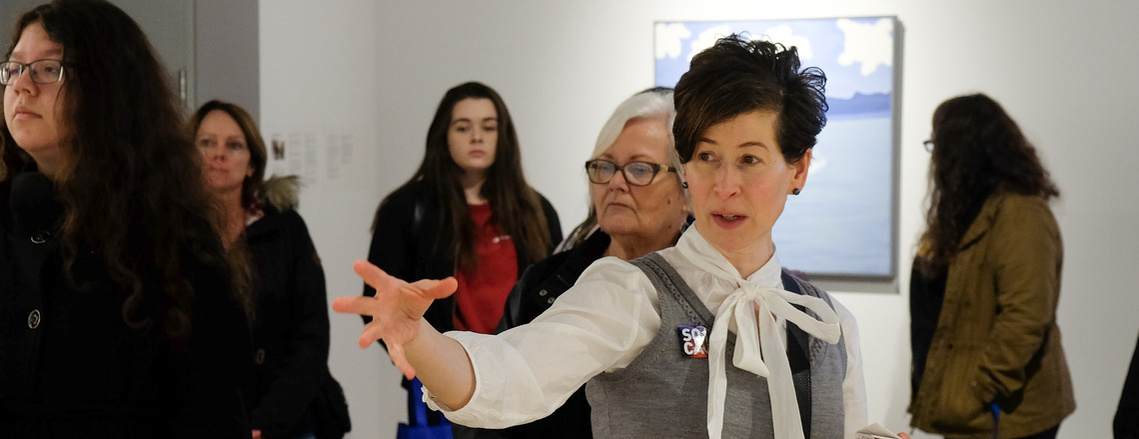 This is an image of me in the SoCA gallery describing a work of art. 