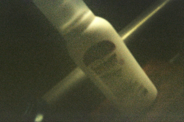 A very grainy film picture of a bottle of testosterone.