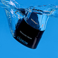 Hydrating face cream splashing into water by Marcie Raw, Melbourne product photographer