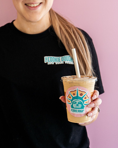 a young girl holding a shake