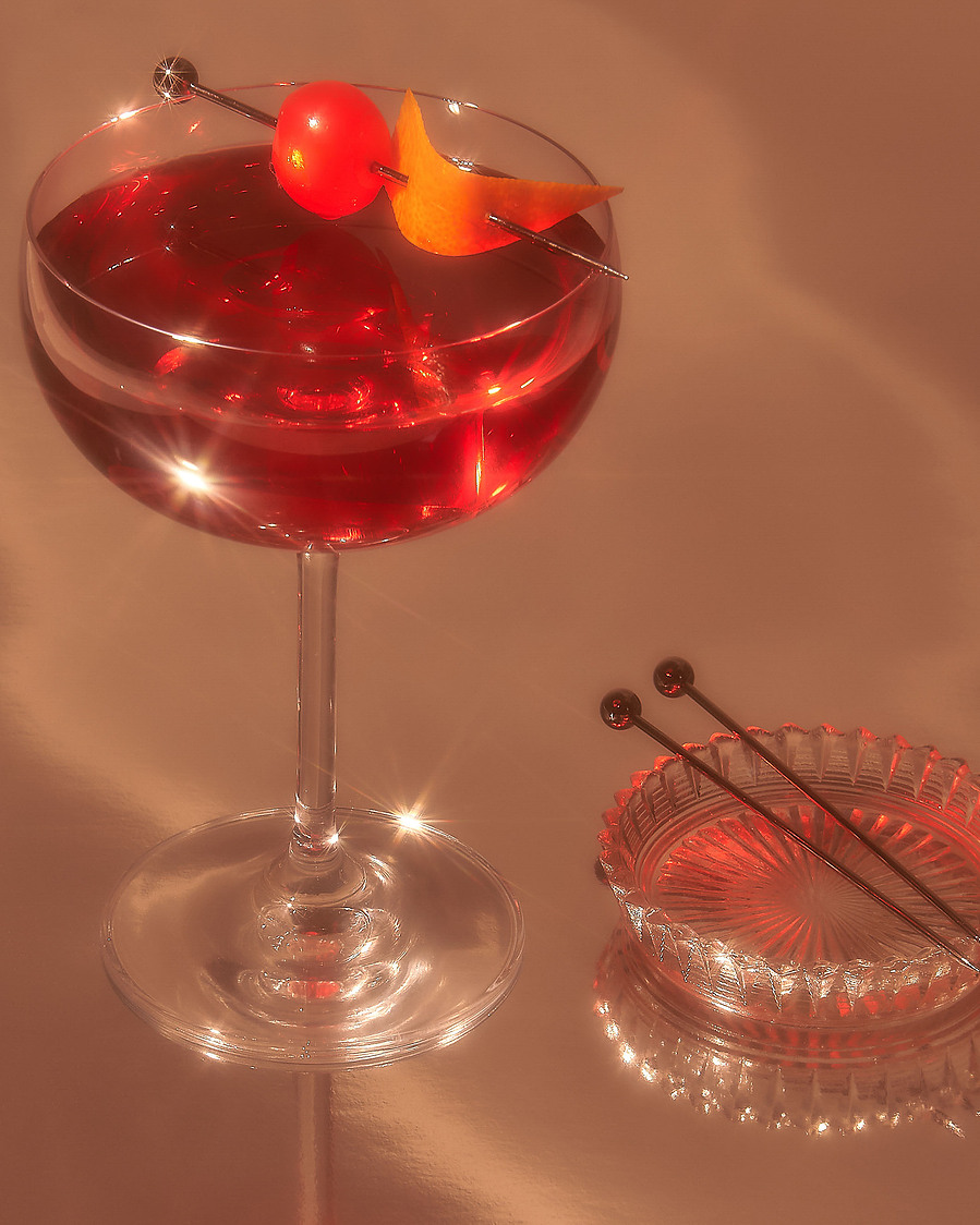 red cocktail with a cherry on top 