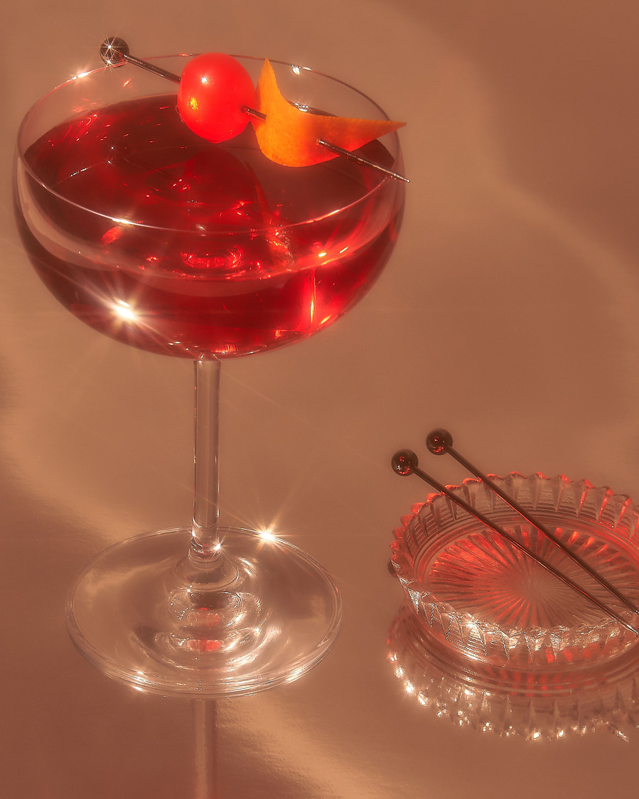 red cocktail with a cherry on top 