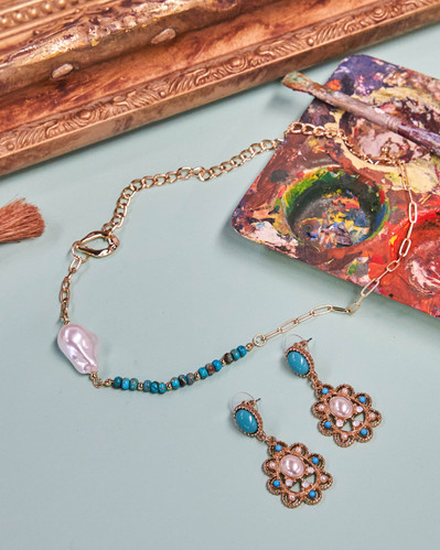 a jewelry set on a blue background