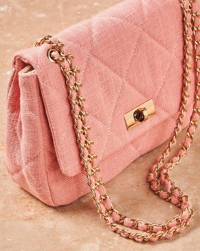 baby pink bag on a stone surface