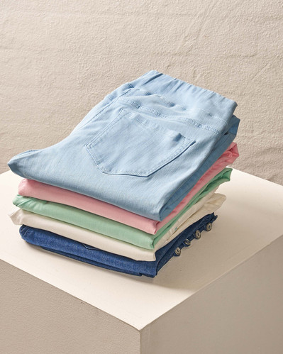a stack of colourful pants sitting on a white plinth