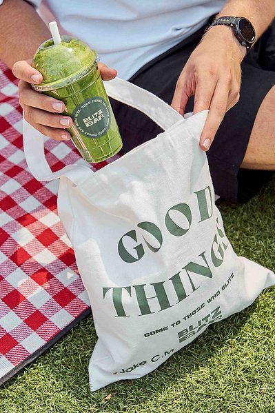 Close-up of green smoothie and takeaway bowl during picnic – Melbourne food lifestyle photography by Marcie Raw