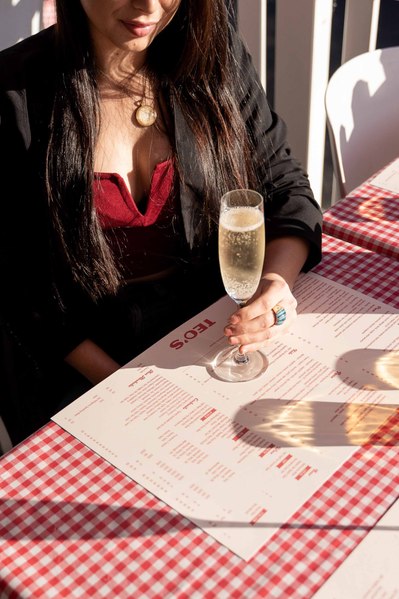 a girl enjoying a Prosecco glass outside in a restaurant 