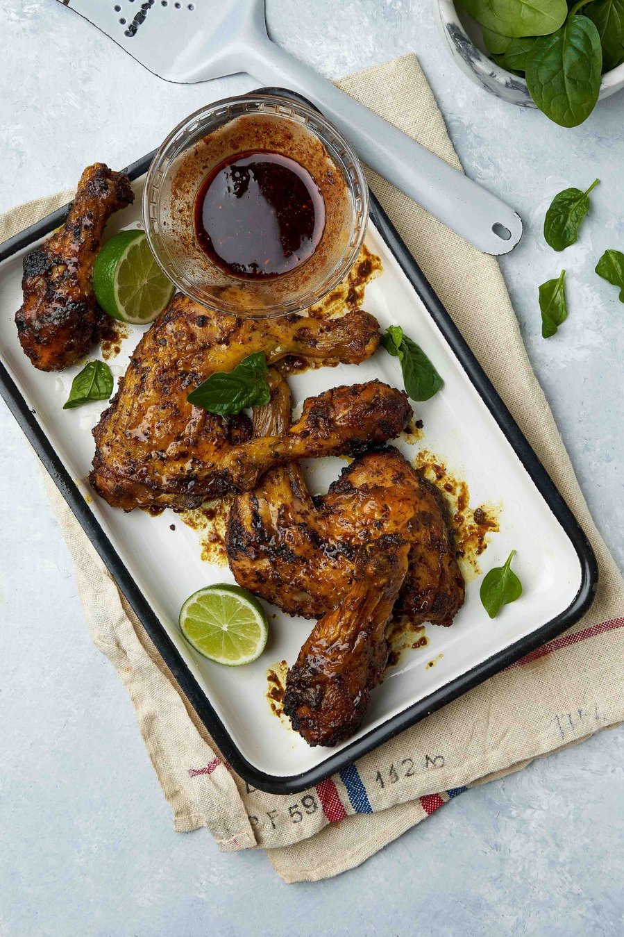 a long plate with cooked chicken thighs 