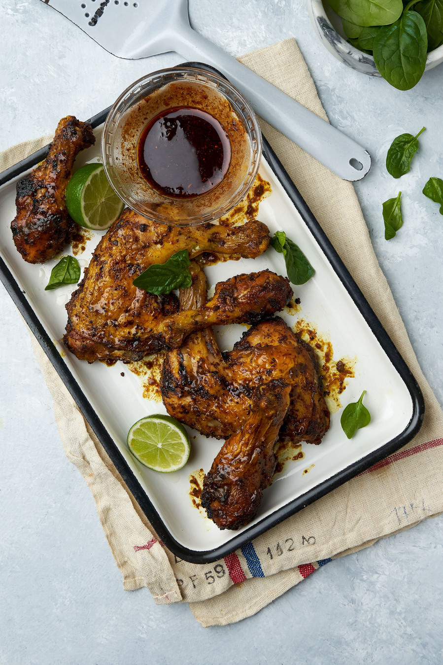 chicken thighs placed on a tray on a white table