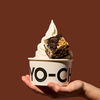 Hand holding Yo Chi frozen yoghurt with brownie — product photography Melbourne