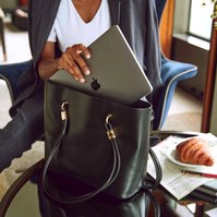 Businesswoman with laptop and luxury handbag by Marcie Raw, Melbourne commercial photographer