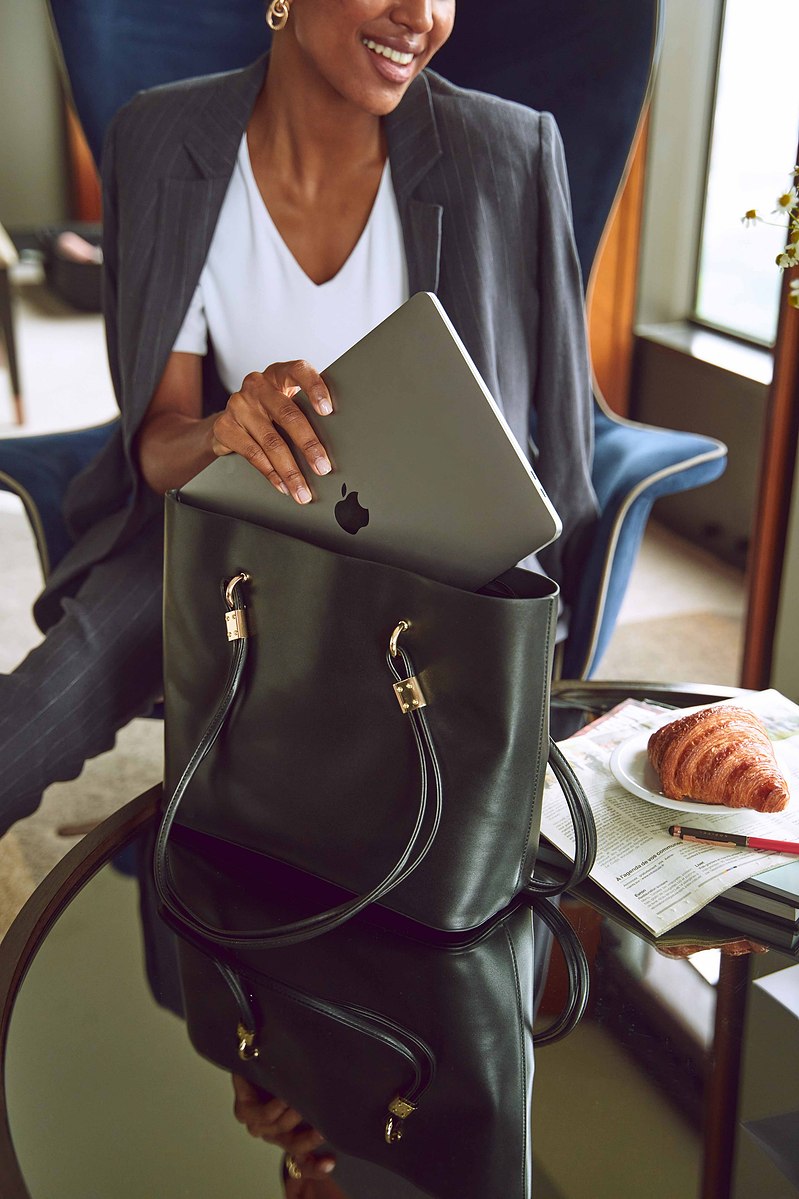 Businesswoman with laptop and luxury handbag by Marcie Raw, Melbourne commercial photographer