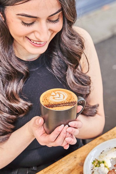 a girl enjoying a mug of coffee