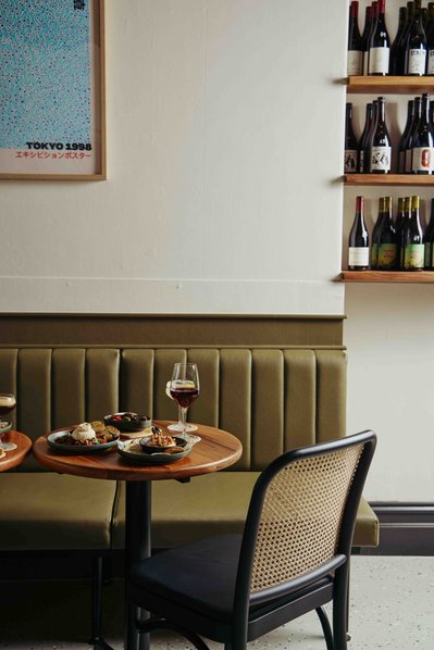 a wine glass and olives on a table in a wine bar