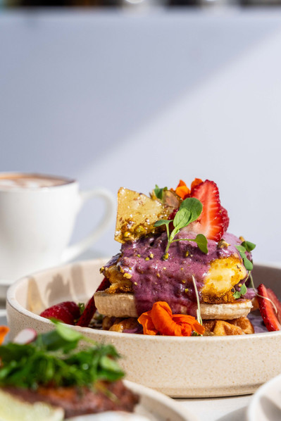 colourful waffles with berry yoghurt topping and fresh fruits 