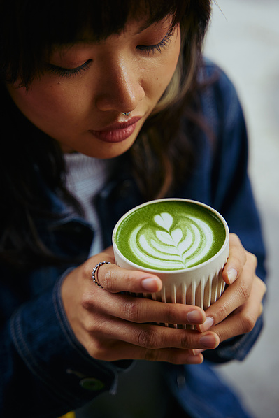 "Woman holding matcha latte in ceramic cup – lifestyle food photography by Marcie Raw, Melbourne