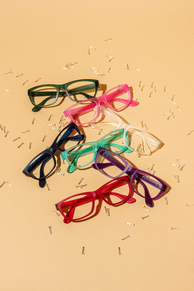 six glasses lying on a beige background