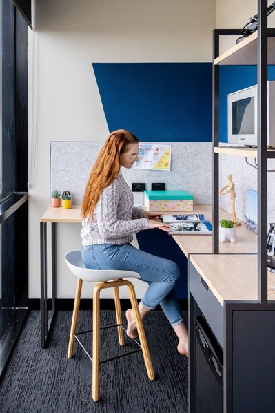 a student sitting at the desk reading a book 