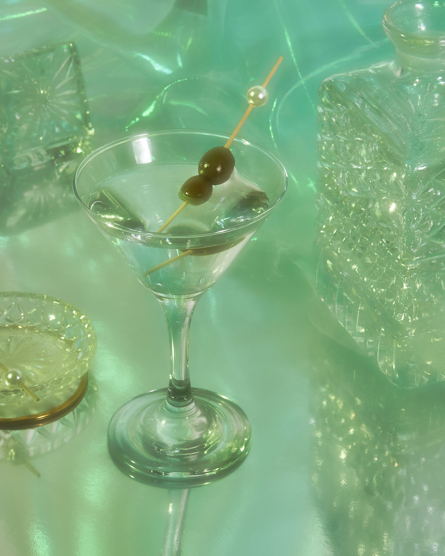 martini drink in a tall glass with olives