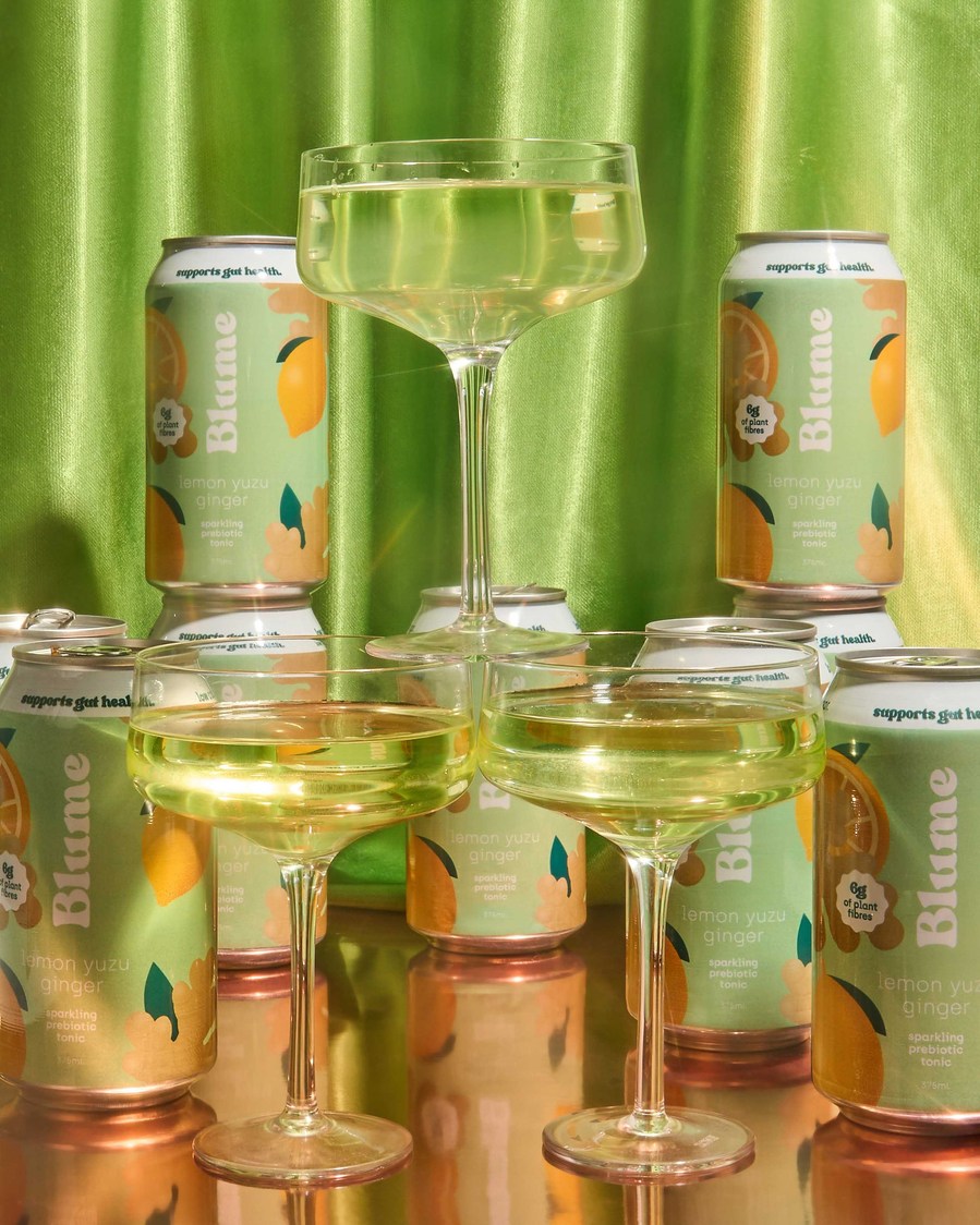 a tower built from cocktail glasses filled with green kombucha
